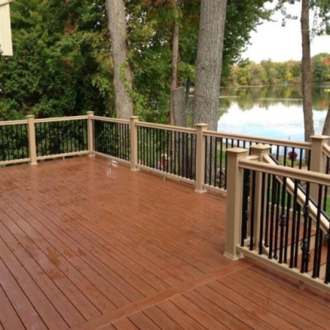 Brand new all wooden deck on the back of a house that looks over the lake