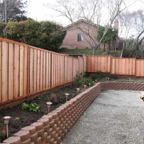 Brand new all wooden fence in the backyard of a house