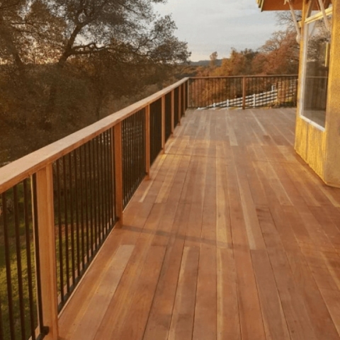 Brand new deck remodel on the outside of house surrounded by trees