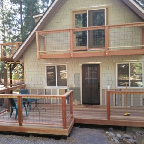 Fully remodeled wooden upper and lower deck outside of house